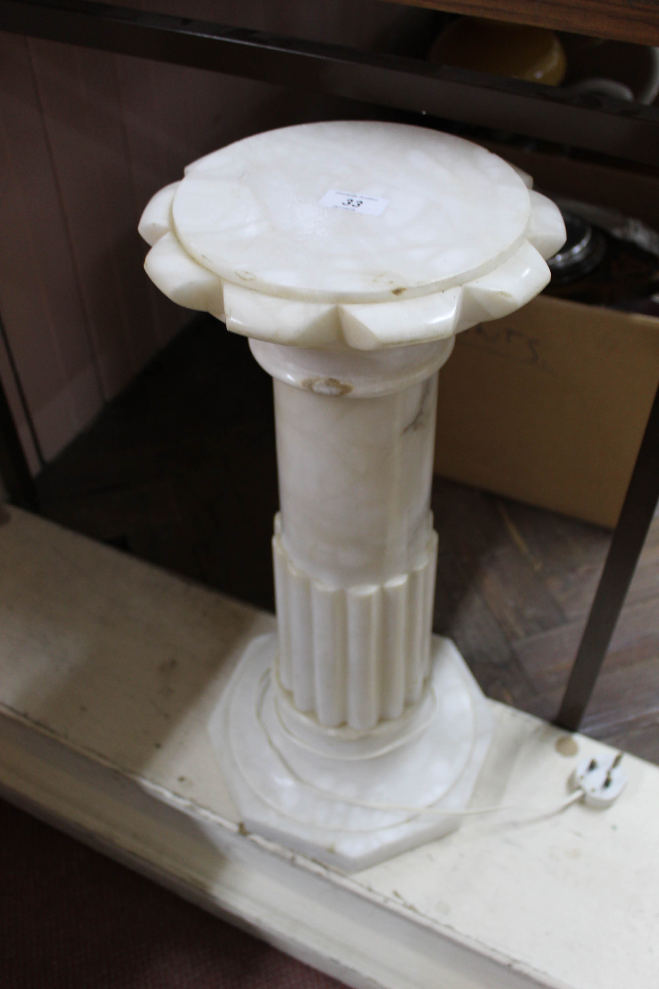 An alabaster floor standing internally illuminated lamp