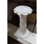 An alabaster floor standing internally illuminated lamp