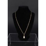 A 9ct gold necklace with yellow metal mounted pearl pendant