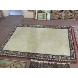 A red bordered cream ground carpet,