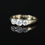 A 9ct gold ring set with three white stones,