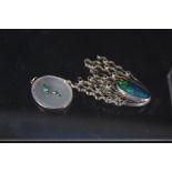 A large abstract silver brooch set with oval opal effect stone and small blue stones,