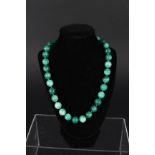 A jade bead necklace with white metal clasp
