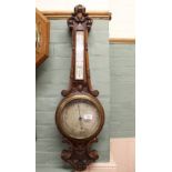 A carved oak aneroid barometer, dial marked Arthurs,