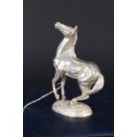 A silver model of a horse titled 'Playing Up',