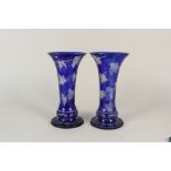 A pair of Bohemian blue overlaid glass vases with etched vine leaf decoration,