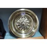 A 19th Century brass alms type bowl with central boss circled by gadrooning,