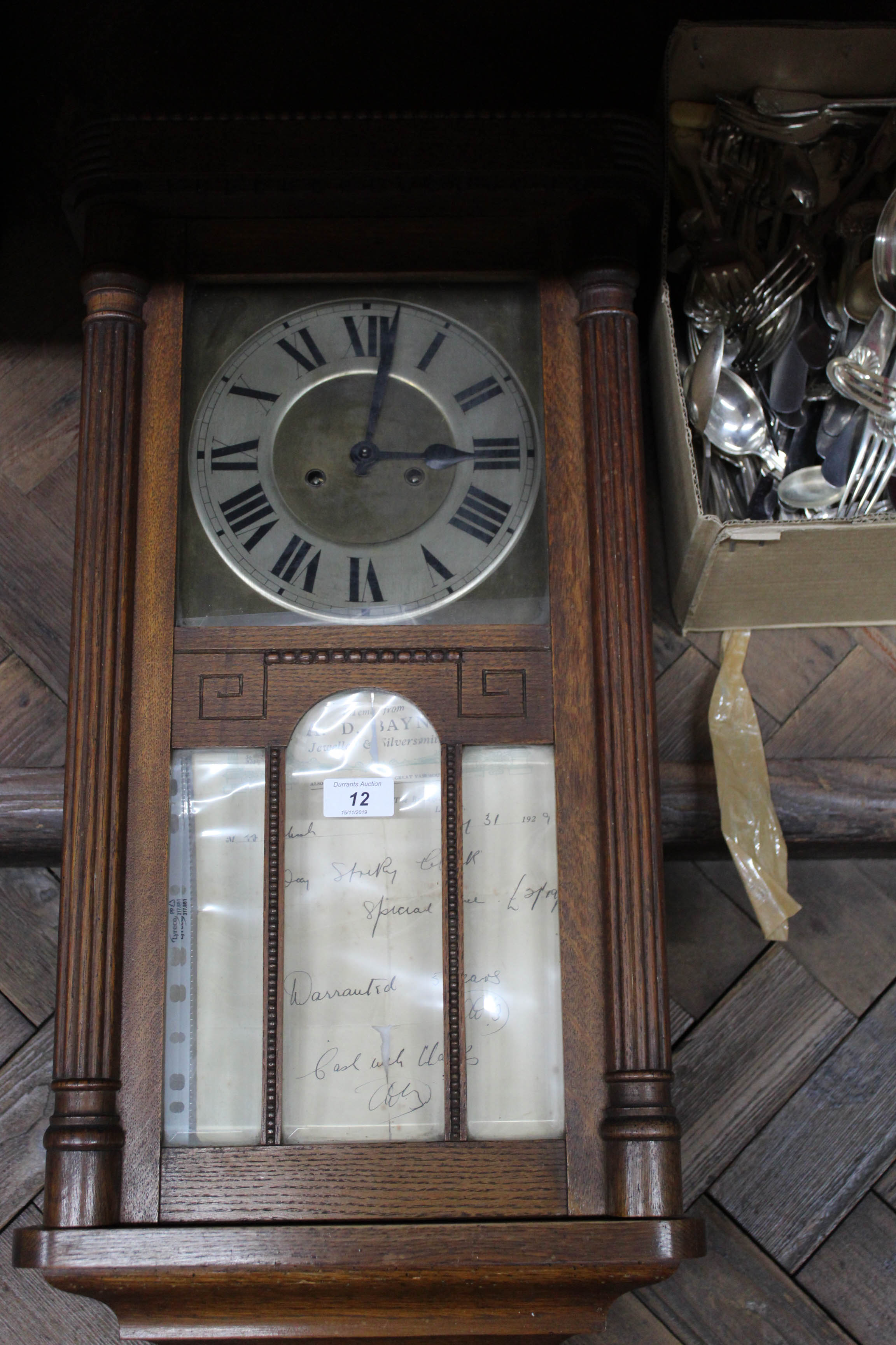 An oak cased wall clock