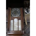 An oak cased wall clock