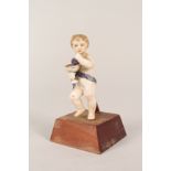 A 19th Century continental porcelain putto holding a bowl of grapes,
