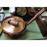 A large 19th Century seamed copper cooking pan and lid with tubular handle,
