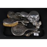 A selection of silver and white metal items including brushes, mirror, spectacle case,