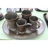 A 19th Century oval pewter plate plus four 19th Century tankards