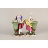 A pair of continental porcelain figures holding baskets,