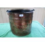 A 19th Century Dutch copper log bin with embossed farmer and cow decoration