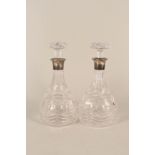 A pair of silver rim cut glass decanters