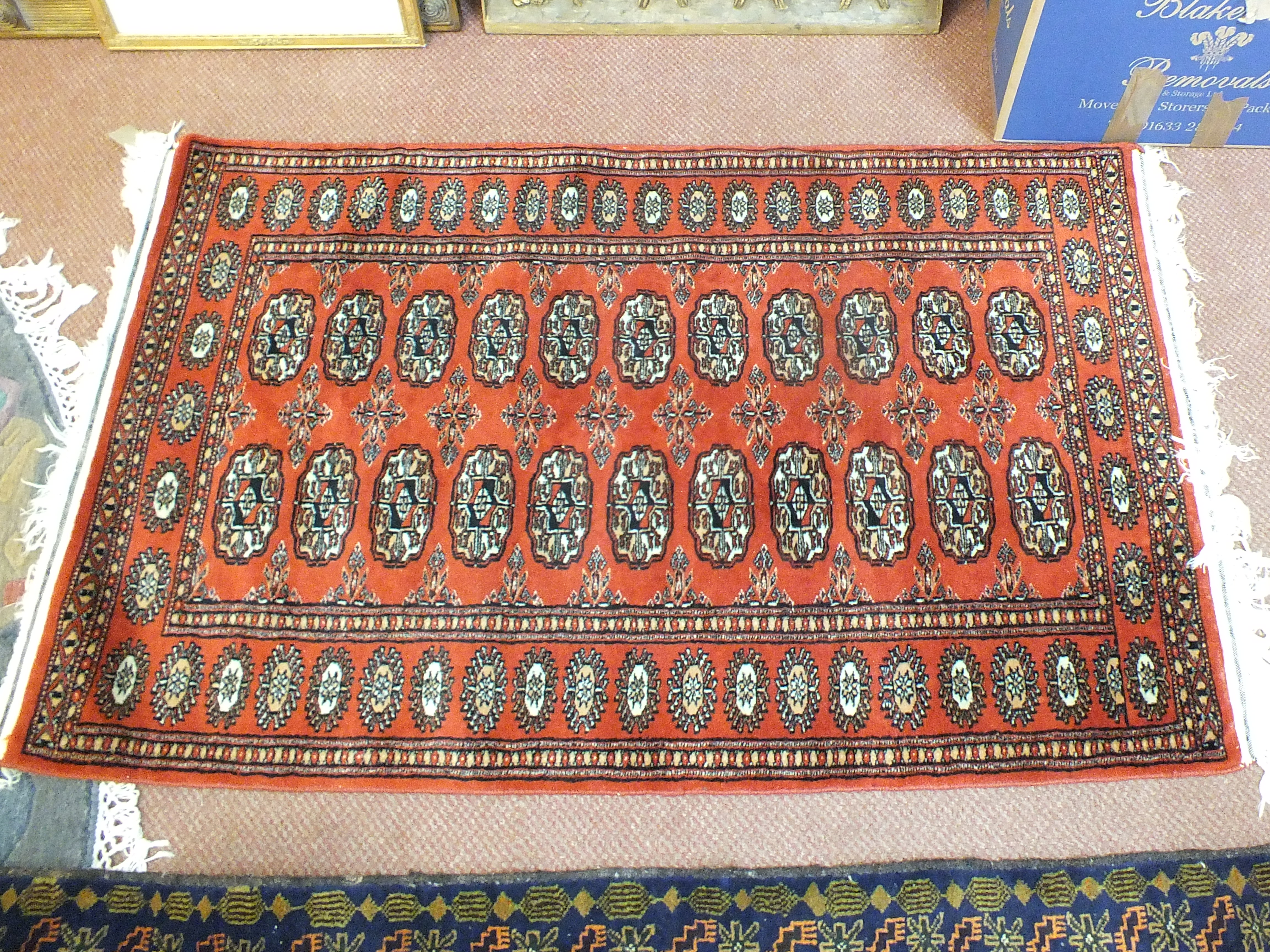 A Persian style red ground rug,