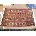 A Persian style red ground rug,