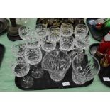 A set of twelve Waterford cut stem wine glasses plus two Waterford jugs