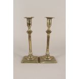 A pair of 18th Century seamed brass candlesticks with detachable sconces,