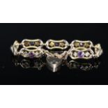 A 9ct gold bracelet set with amethyst and seed pearls (one pearl missing) with 9ct gold heart