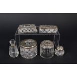 Five glass silver lidded jars including hair tidy and a glass silver collared scent bottle