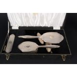 A four piece silver backed dressing table set (comb as found) plus a silver backed nail buffer