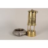 A brass miners lamp by The Lamp and Limelight Co,