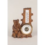 A Black Forest bear barometer/thermometer,