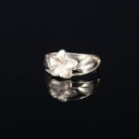 A yellow metal ring with pierced floral decoration stamped 14K,