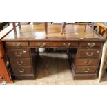 A large late 19th Century nine drawer pedestal desk with leather inset top