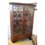 A George III oversized glazed corner cupboard on a two drawer stand