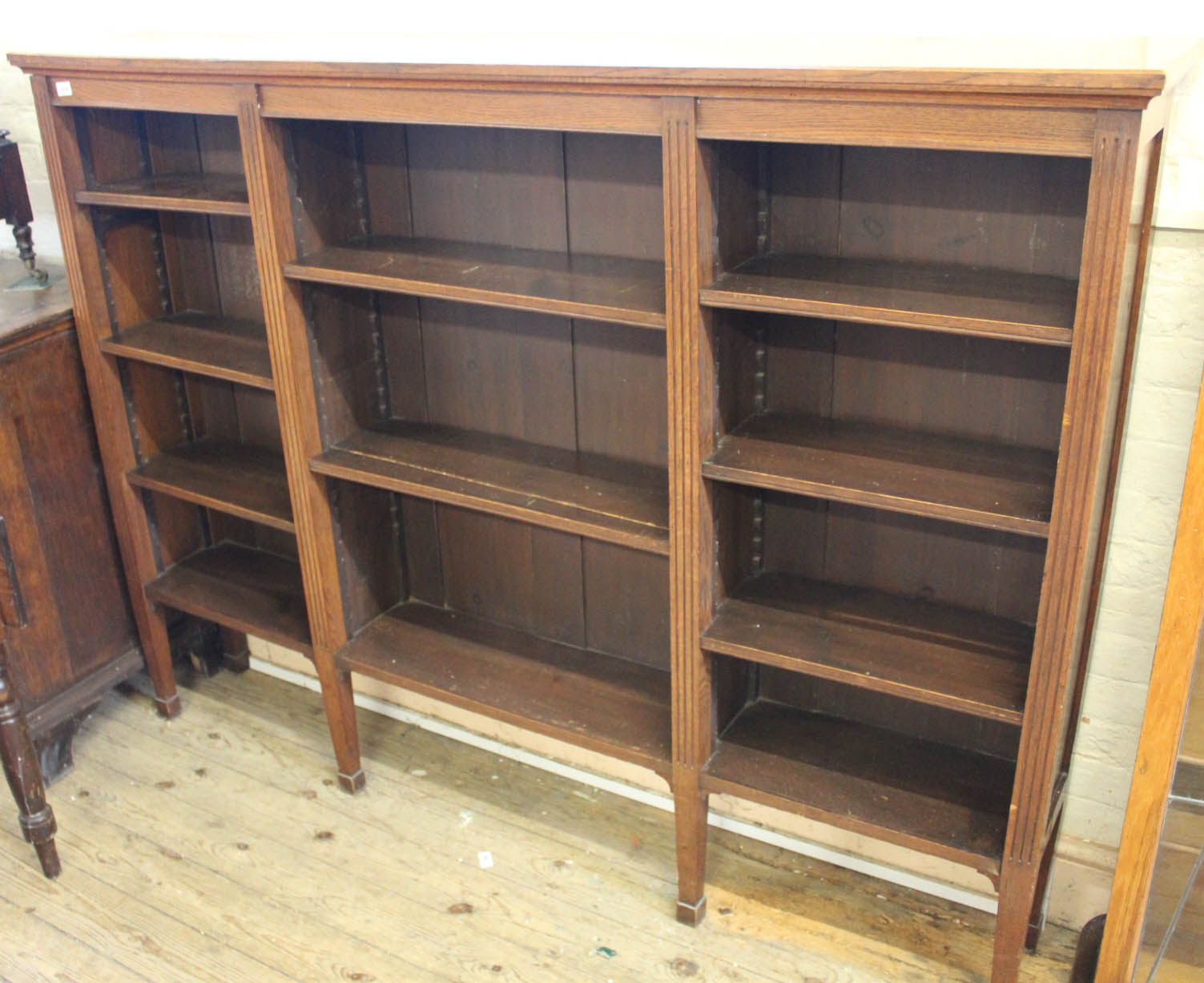 A 1920's oak adjustable bookcase of large proportions