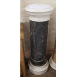 A black marble column with white marble top and base