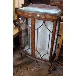 A 1950's rosewood glazed display cabinet on ball and claw feet