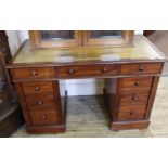 A late Victorian mahogany nine drawer pedestal desk with faded leather inset top and lockable side