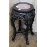 An ebonised Oriental style plant stand with inset marble top
