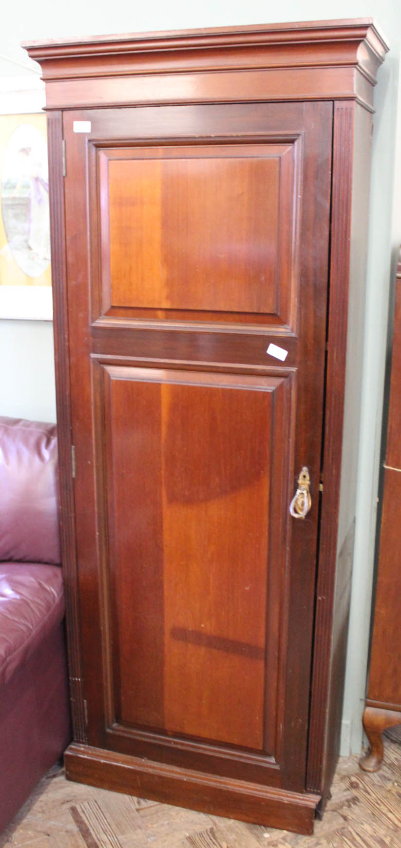 An Edwardian mahogany cupboard with shelved interior