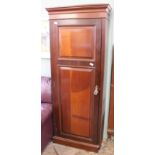 An Edwardian mahogany cupboard with shelved interior