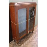 A 1930's glazed bookcase on cabriole legs