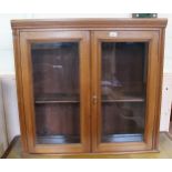 An Edwardian mahogany glazed two door wall hanging bookcase