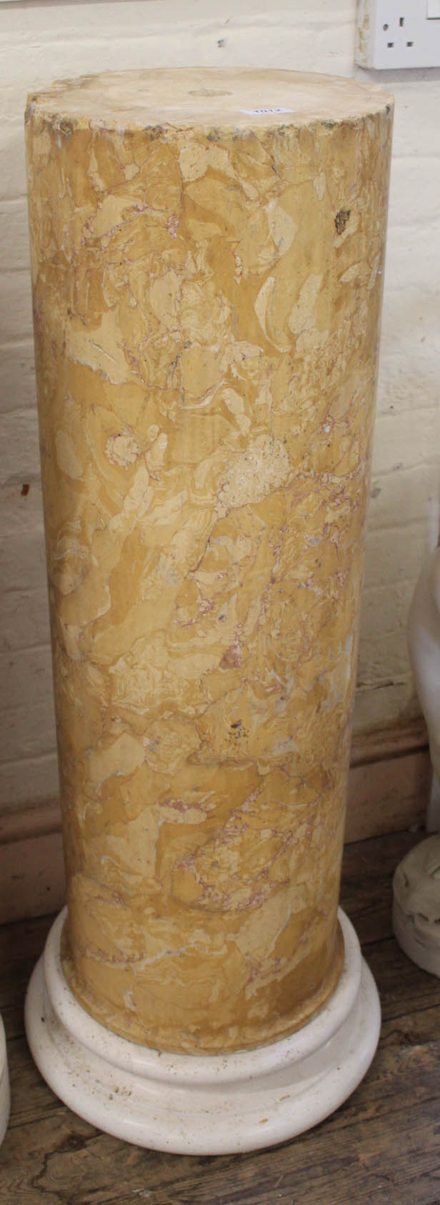 A composite granite column on white marble base
