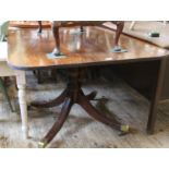 An early 19th Century mahogany dining table with reeded legs and reeded rim top