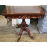 A Victorian carved mahogany card table