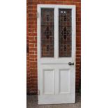 A vintage external door with stained glass panels