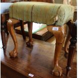 A Victorian piano stool on cabriole legs and ball and claw feet