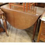 A 19th Century mahogany drop leaf oval dining table on pad feet