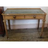 A late 19th Century ash two drawer writing desk with green leather top