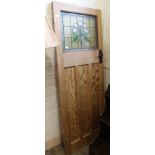 A pitch pine door with lead lined glass panel and Art Deco style bakerlite handle