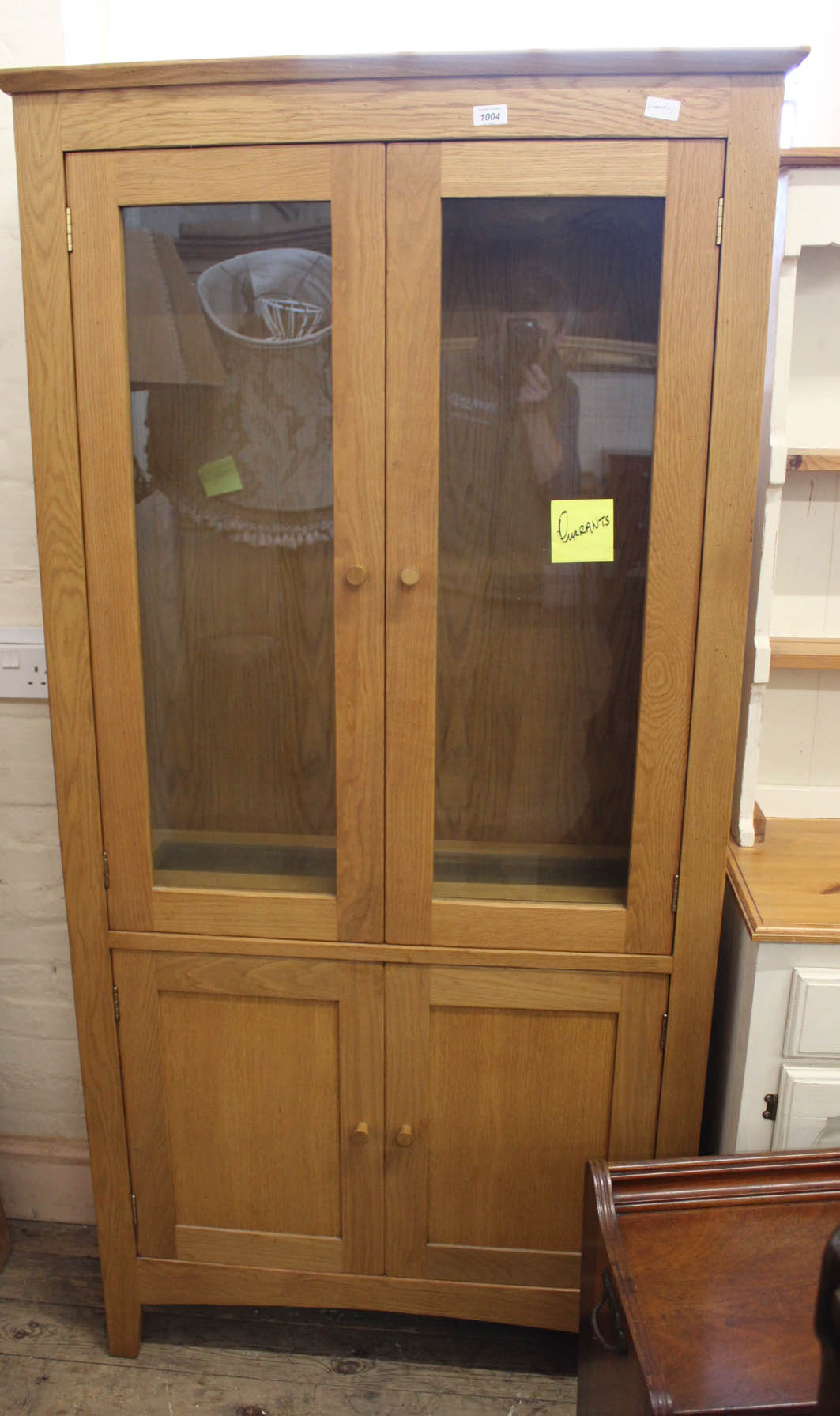 A modern two part glazed oak display cabinet